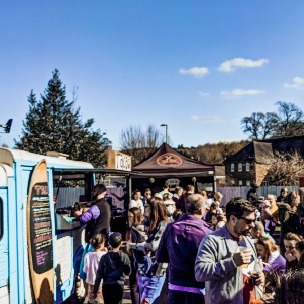 A crowd of people and street food vans at Nonna's Street Food Festival