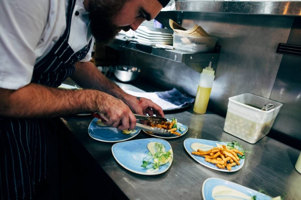 Chef serving calamari at Olé Tapas Bar