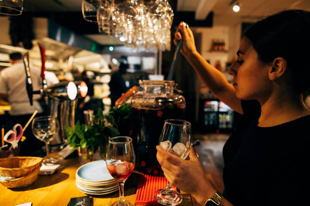 A waitress pouring sangria at Olé Tapas Bar